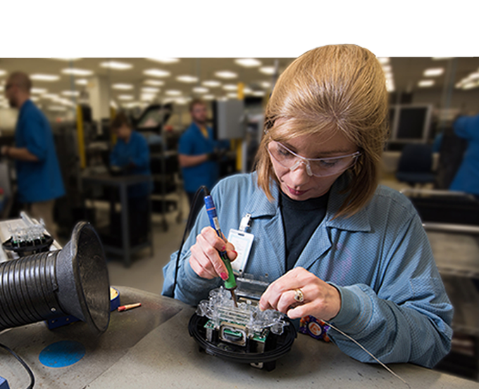 A woman soldering electronic compoenents.